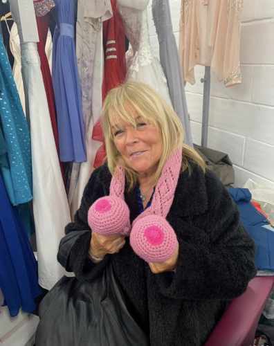 TV star Linda Robson wearing Hug In A Shrug group’s boob scarf at Lady McAdden Breast Cancer Trust's Pop Up at The Royals Shopping Centre on Saturday February 18